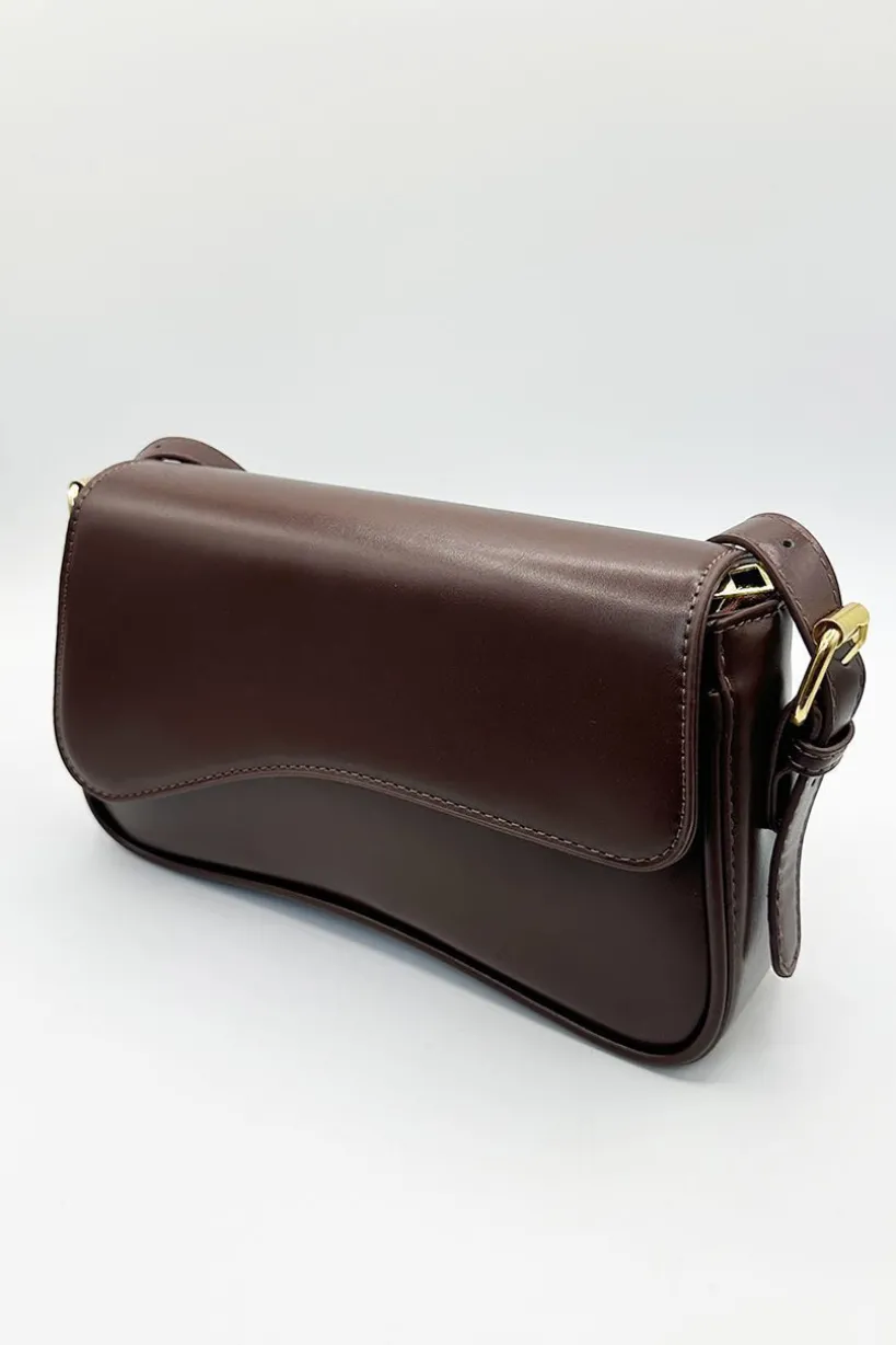 Curved Baguette Bag In Dark Brown by SVNX