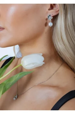 Flower Drop Pearl Earrings In Silver by SVNX