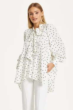 Polka Dot Ruffle High-Low Blouse by Liquorish