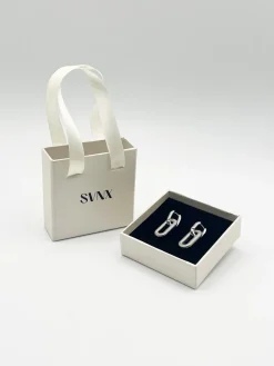 Ribbed Oval Hoop Earrings In Silver by SVNX
