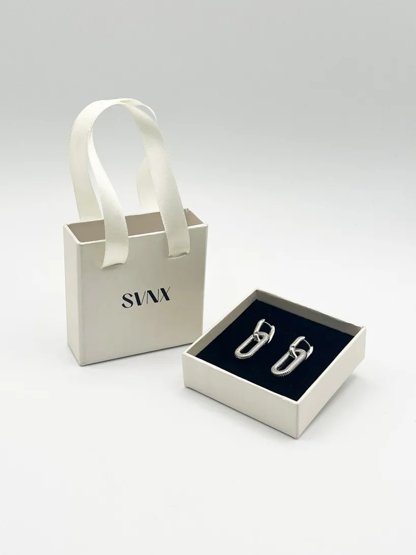 Ribbed Oval Hoop Earrings In Silver by SVNX
