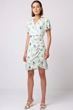 Wrap Ruched Mini Dress With Ruffle Hem In Green Floral Burnout Print by Angeleye