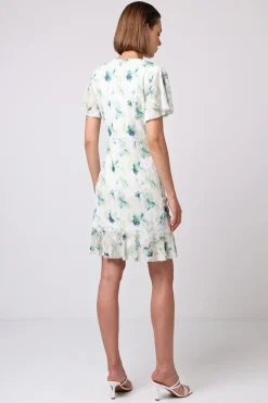 Wrap Ruched Mini Dress With Ruffle Hem In Green Floral Burnout Print by Angeleye